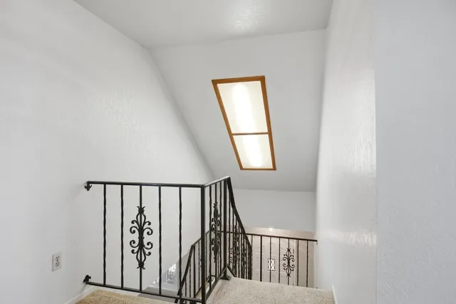 a bathroom with a granite countertop sink toilet and mirror
