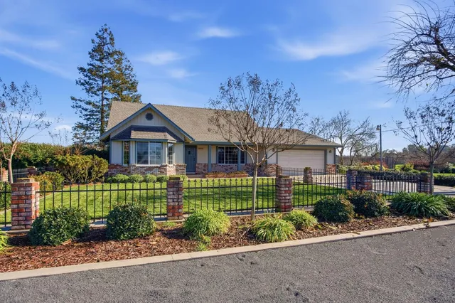 a front view of a house with a garden