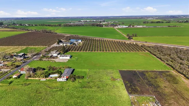 an aerial view of a houses with a yard
