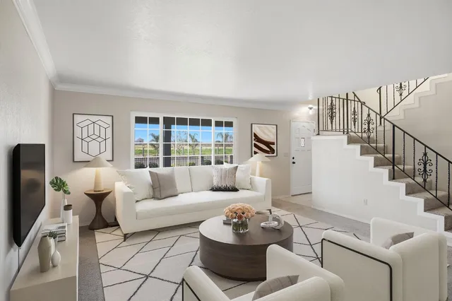 a living room with furniture and a large window