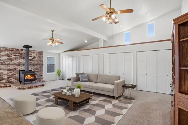 a living room with furniture a fireplace and a flat screen tv