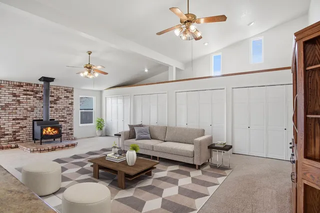 a living room with furniture a fireplace and a flat screen tv