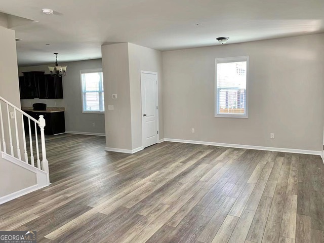 177 Dunleith Parkway Southwest Marietta, GA 30008 - Photo 5 of 17 an empty room with wooden floor and windows