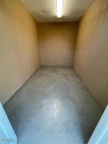 a view of an empty room and a window