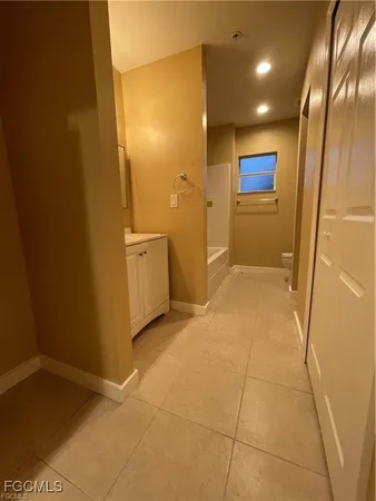 a bathroom with a sink a toilet a mirror and vanity