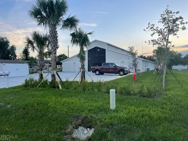 a view of a house with a backyard and a garden