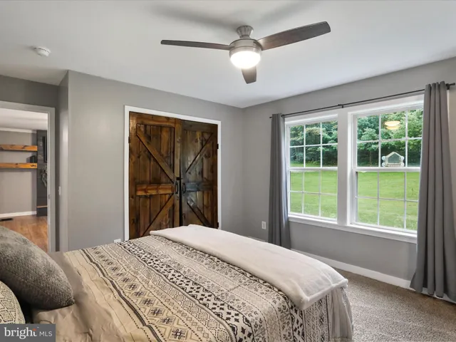 a bedroom with a large bed and a large window