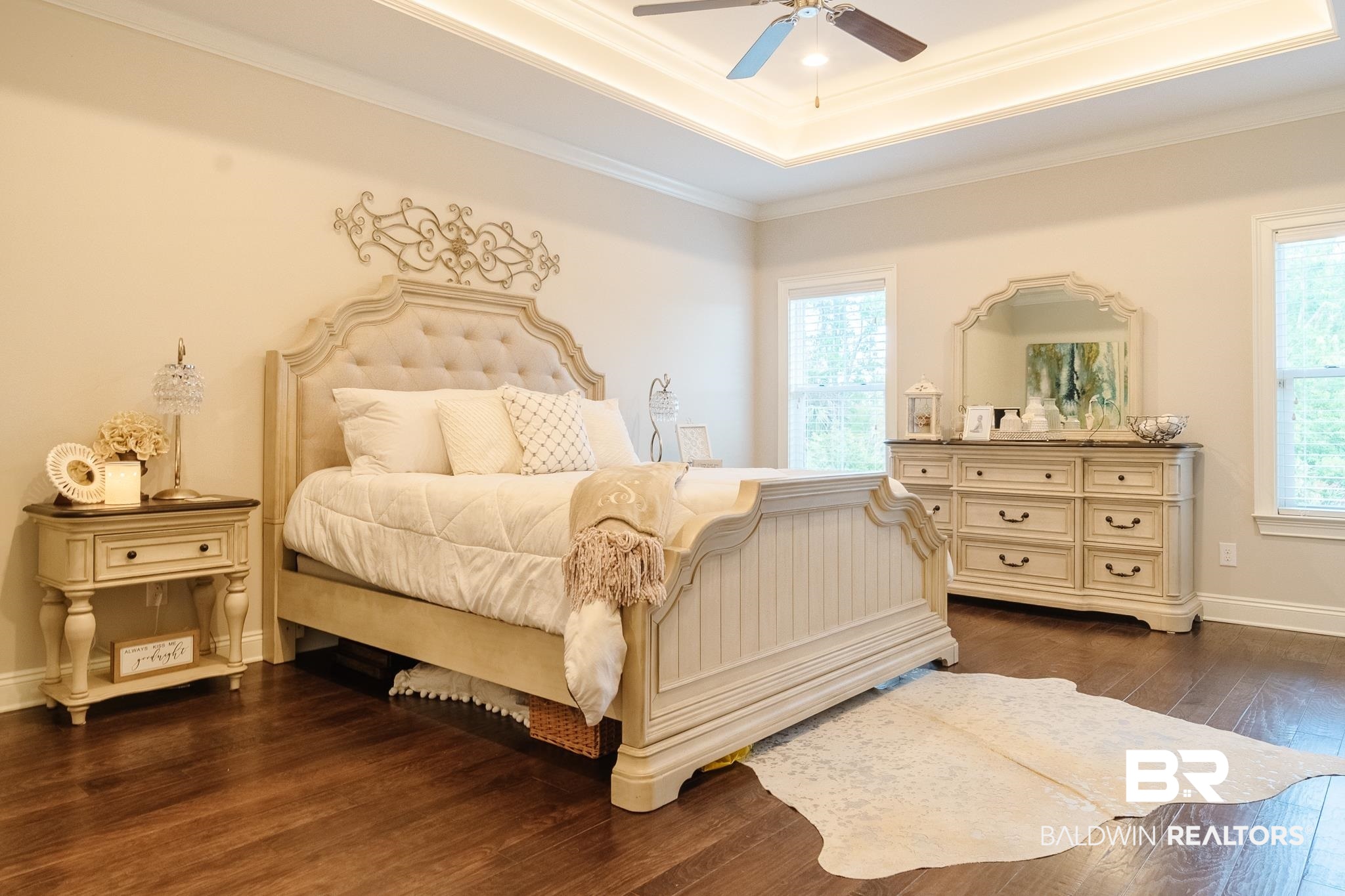 7235 Raleigh Way Mobile, AL 36695 - Photo 16 of 52 Bedroom featuring crown molding, a tray ceiling, baseboards, dark wood finished floors, and a ceiling fan