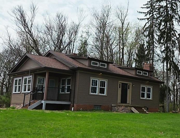 460 Beaver Run Road Apollo, PA 15613 - Photo 2 of 47 a front view of a house with a garden and yard
