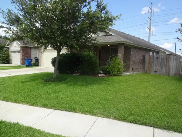 a front view of a house with a garden and yard