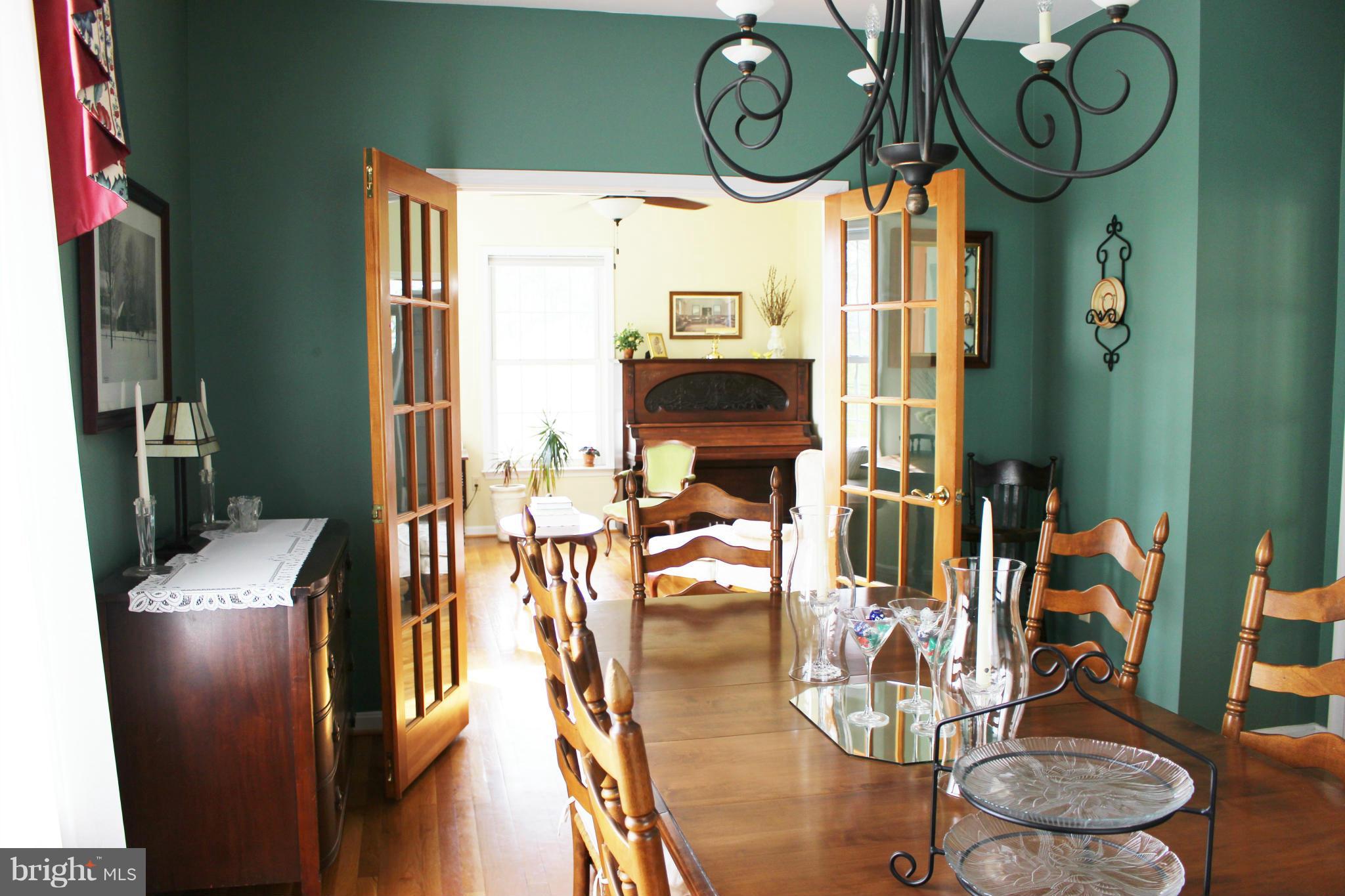 245 Milldale Road Front Royal, VA 22630 - Photo 11 of 29 a view of a dining room with furniture wooden floor and a chandelier