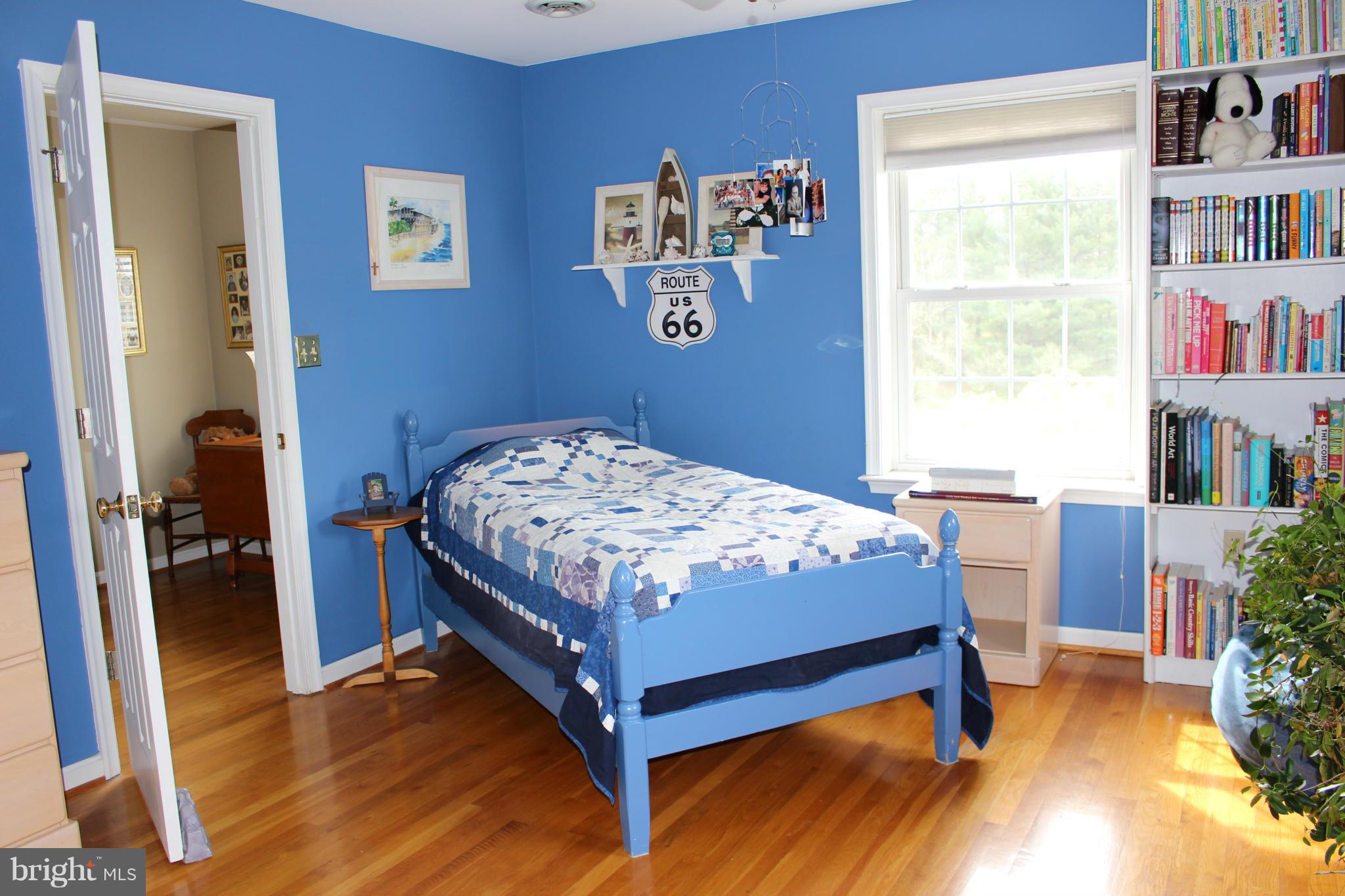 245 Milldale Road Front Royal, VA 22630 - Photo 16 of 29 a bedroom with a bed and a book shelf