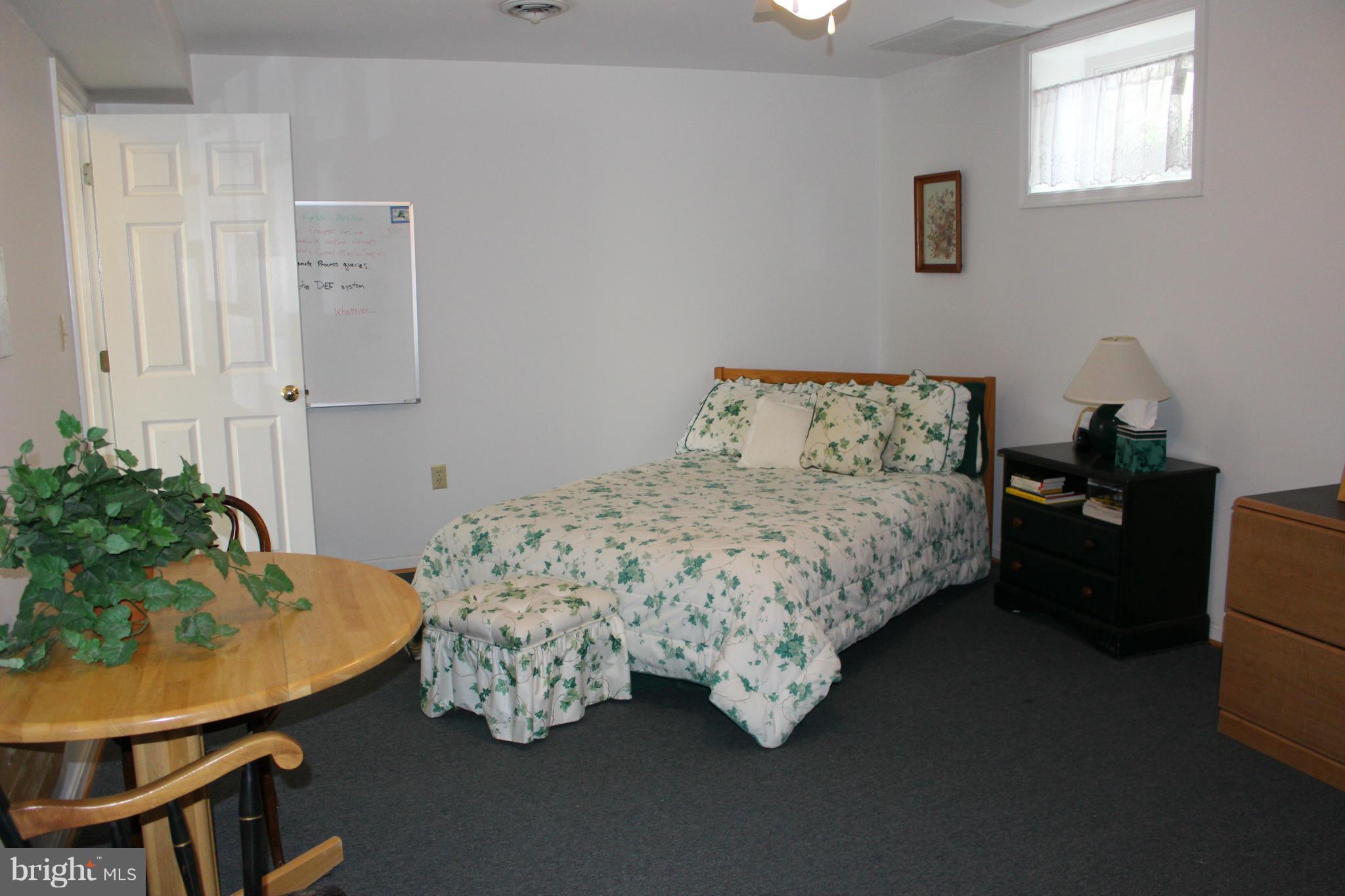 245 Milldale Road Front Royal, VA 22630 - Photo 24 of 29 a bedroom with a bed table chair and a window