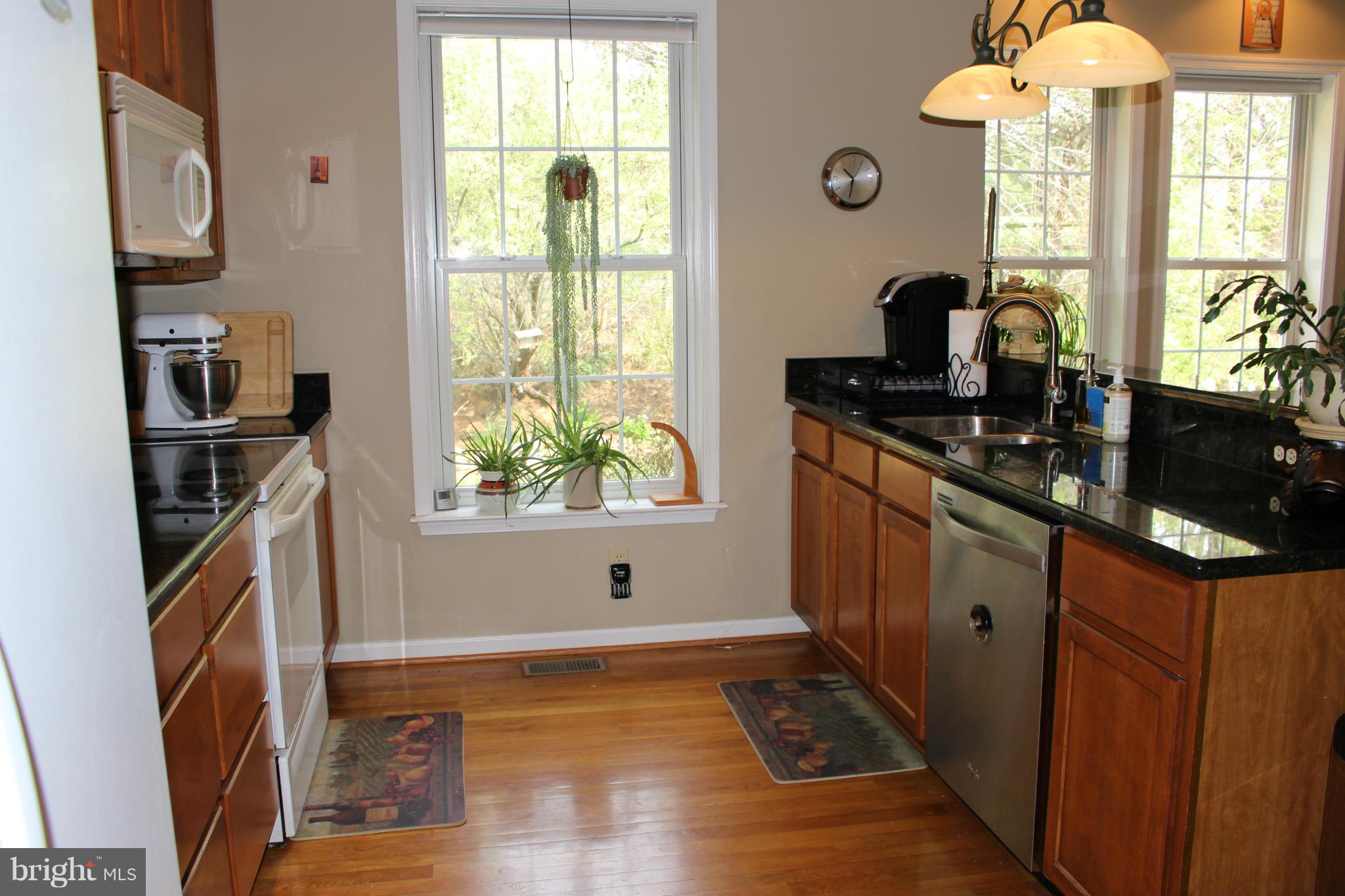 245 Milldale Road Front Royal, VA 22630 - Photo 5 of 29 a kitchen with stainless steel appliances granite countertop a stove a sink and a refrigerator