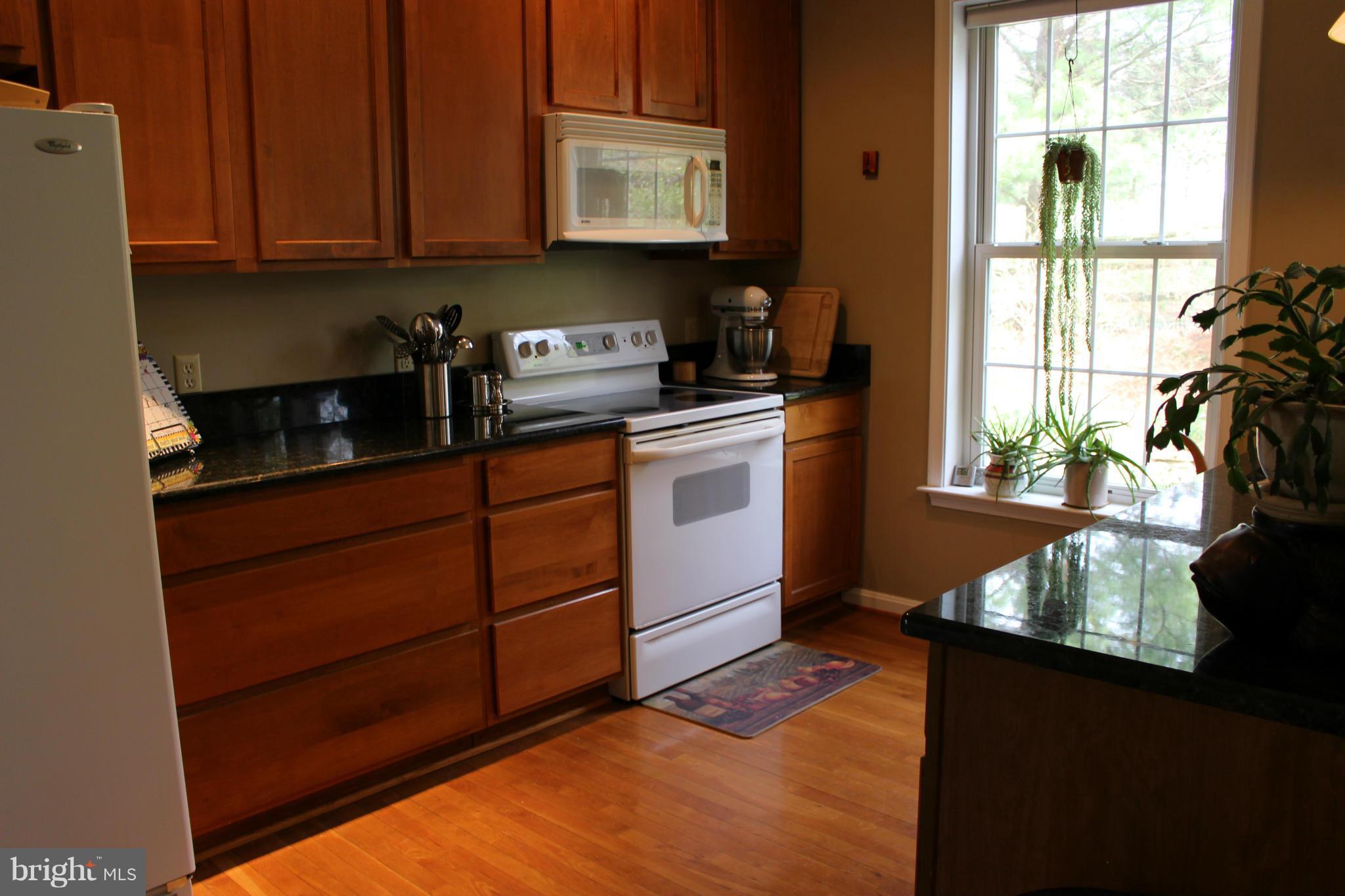 245 Milldale Road Front Royal, VA 22630 - Photo 6 of 29 a kitchen with stainless steel appliances granite countertop a stove a sink and a refrigerator