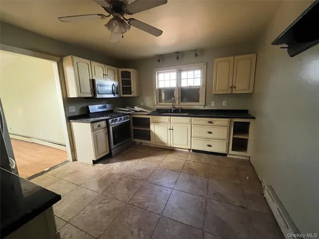 a kitchen with stainless steel appliances granite countertop a stove and a sink