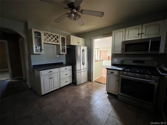 a kitchen with stainless steel appliances a stove a microwave and a refrigerator