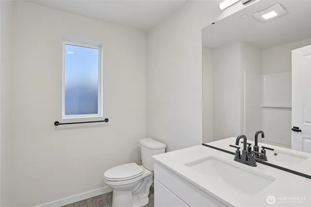 a bathroom with a sink a toilet and mirror