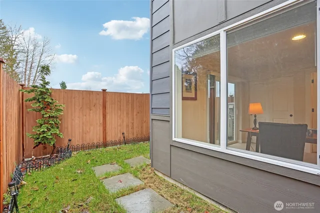 a view of a porch with a table and chairs