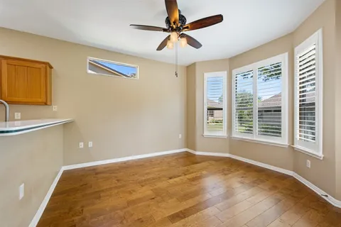 a view of a livingroom with a window and a ceiling fan