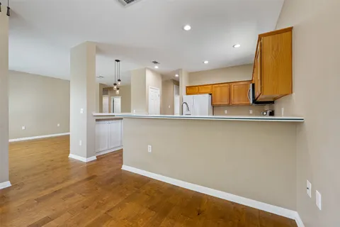 a kitchen with stainless steel appliances a sink and a refrigerator