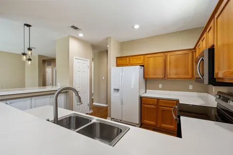 a kitchen with stainless steel appliances a sink and a refrigerator