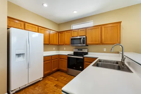 a kitchen with stainless steel appliances granite countertop a sink and stove top oven