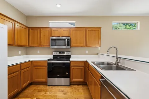 a kitchen with a sink cabinets and stainless steel appliances