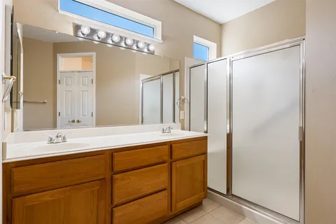a bathroom with a double vanity sink and mirror
