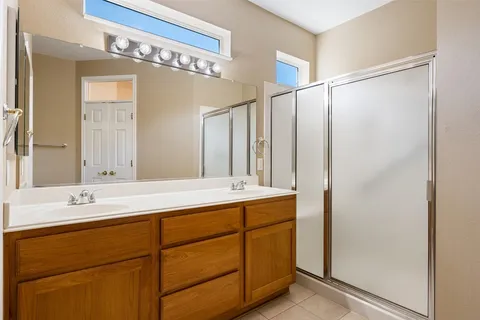 a bathroom with a double vanity sink and mirror