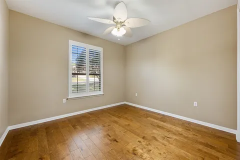 a view of a room with a ceiling fan and a window