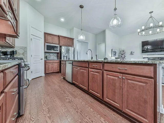 a living room with furniture a chandelier and a dining room