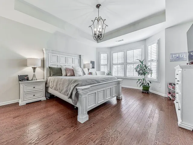 a bathroom with a granite countertop sink and a bathtub