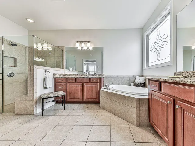 a utility room with granite countertop cabinets washer and dryer