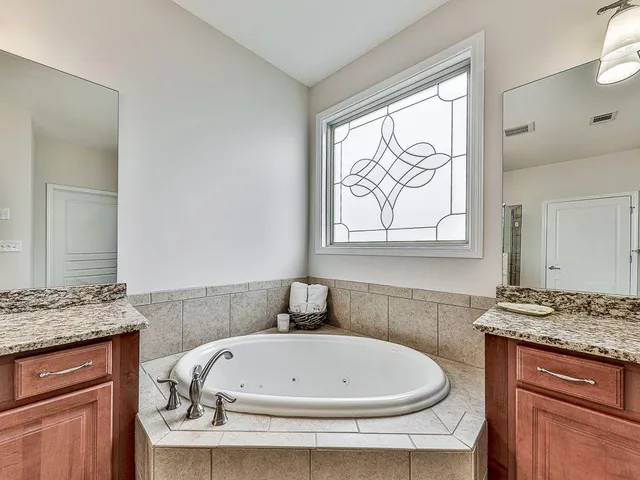 a living room with patio furniture and a garden