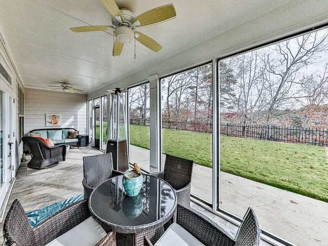 a view of a dining room with furniture a chandelier and wooden floor