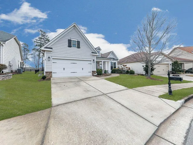 a view of a dining room and livingroom with furniture wooden floor a chandelier