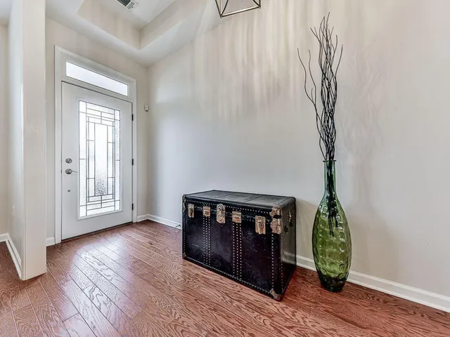 a kitchen with a dining table chairs stainless steel appliances and cabinets