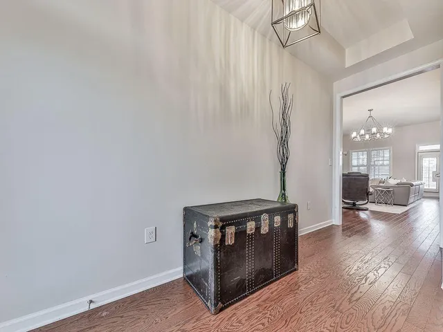 a kitchen with stainless steel appliances granite countertop a sink a stove and a wooden floors