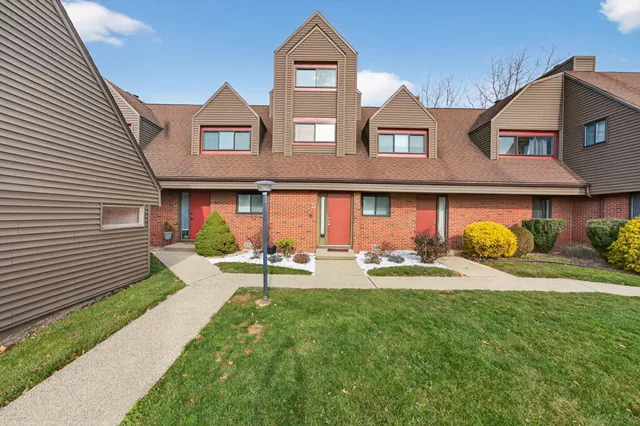 a front view of a house with dining space and garden