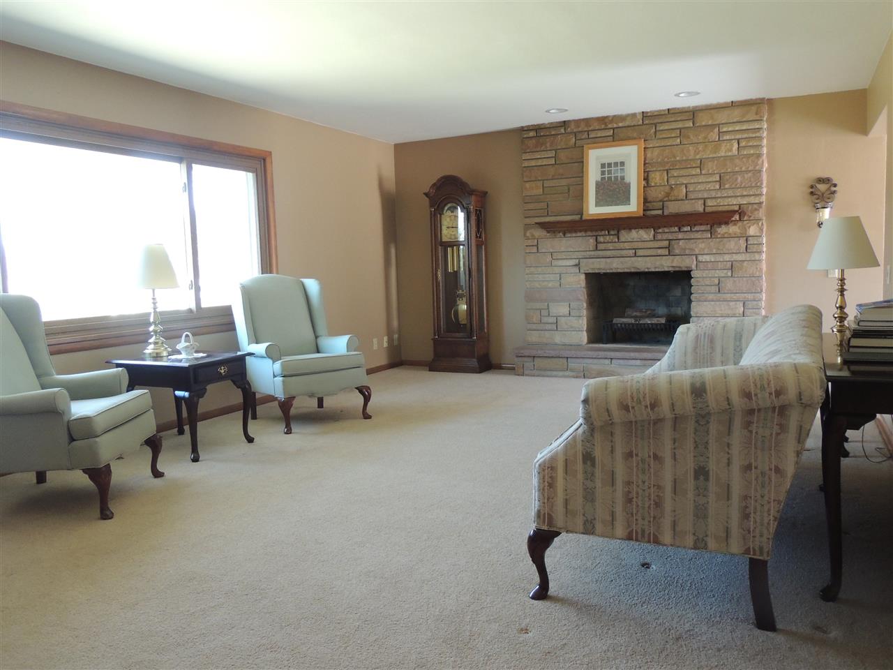 4114 Cushman Road Rockford, IL 61114 - Photo 11 of 25 a living room with furniture and a fireplace