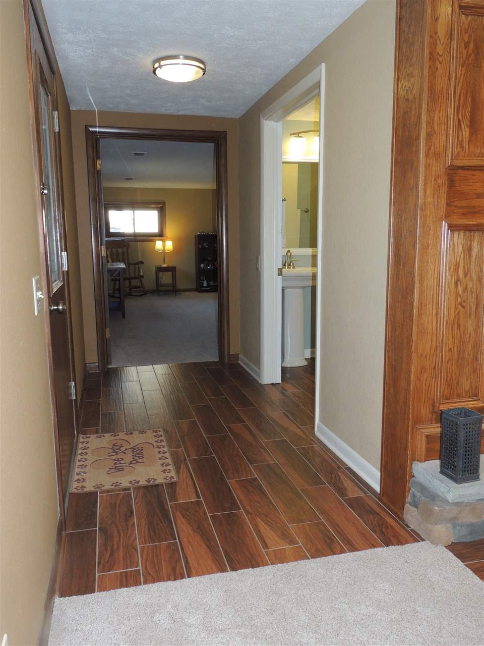 4114 Cushman Road Rockford, IL 61114 - Photo 22 of 25 a view of a hallway view with wooden floor and furniture