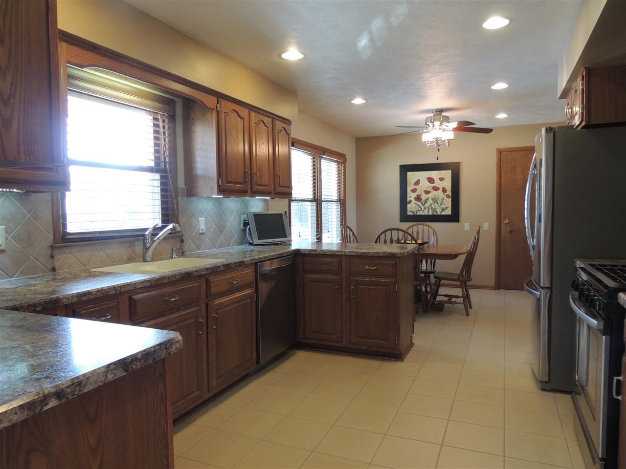 4114 Cushman Road Rockford, IL 61114 - Photo 5 of 25 a kitchen with kitchen island granite countertop a sink appliances and cabinets