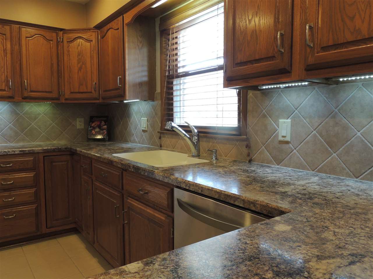 4114 Cushman Road Rockford, IL 61114 - Photo 7 of 25 a kitchen with granite countertop a sink a stove and cabinets