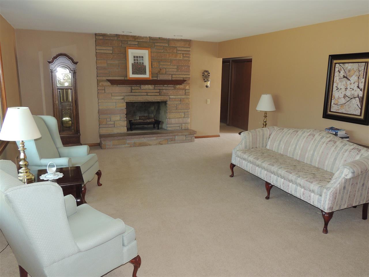 4114 Cushman Road Rockford, IL 61114 - Photo 9 of 25 a living room with furniture and a fireplace