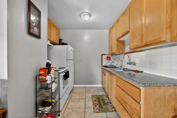 a kitchen with stainless steel appliances granite countertop a sink and a stove