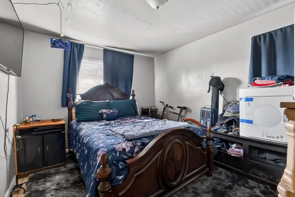 a bedroom with a bed and dresser
