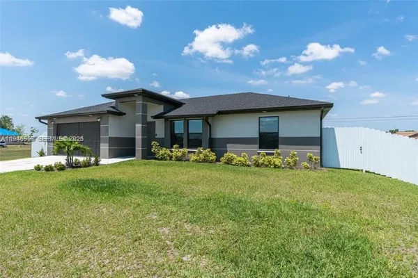 a front view of house with yard and outdoor seating