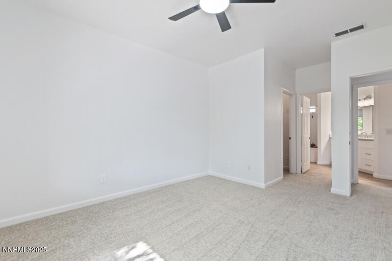 900 South Meadows Parkway, Unit 3322 Reno, NV 89521 - Photo 14 of 35 an empty room with a ceiling fan and carpet