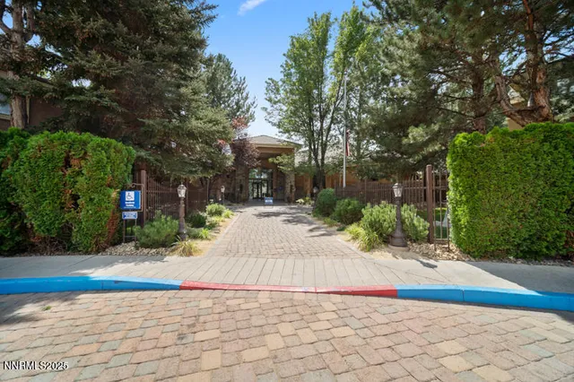a view of yellow house with a yard and plants